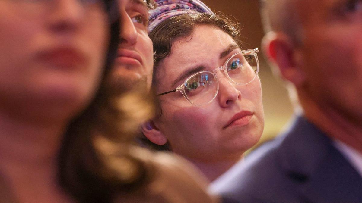 Rabbi Dvir (left) and Shalhevet Cahana (right) listen as Ziv Levy speaks of his sister who was killed on October 7, 2023. The Miami Jewish community gathered at Temple Beth Sholom in remembrance of those who perished in the Oct 7 attacks.