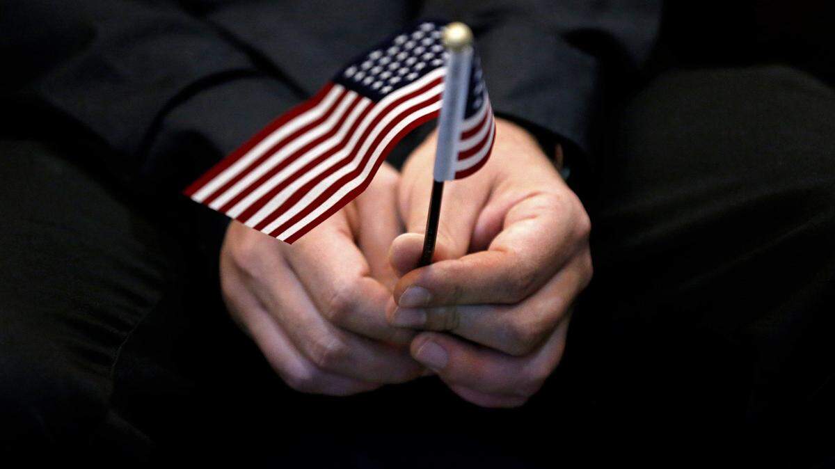 Cubans are no longer being given special immigration status in the U. S. as they had received for six decades. A 2019 photo shows an American flag during a naturalization ceremony at Everglades National Park.