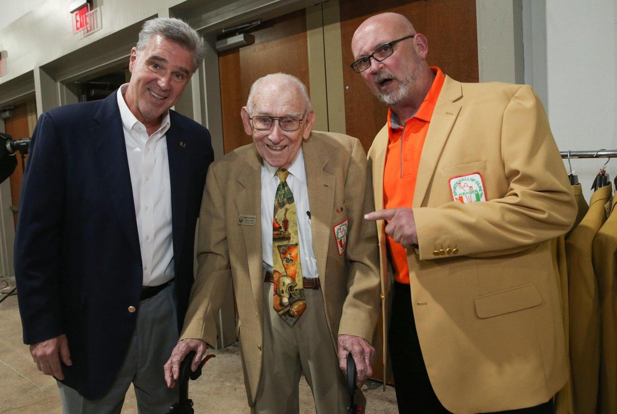 Miami Hurricanes athletic director Dan Radakovich, G. Holmes Braddock and football inductee Jay Brophy pose during the University of Miami Sports Hall of Fame Induction Banquet at the Doubletree by Hilton Miami Airport ConventionCenter in Miami, Florida on Thursday, April 21, 2022.