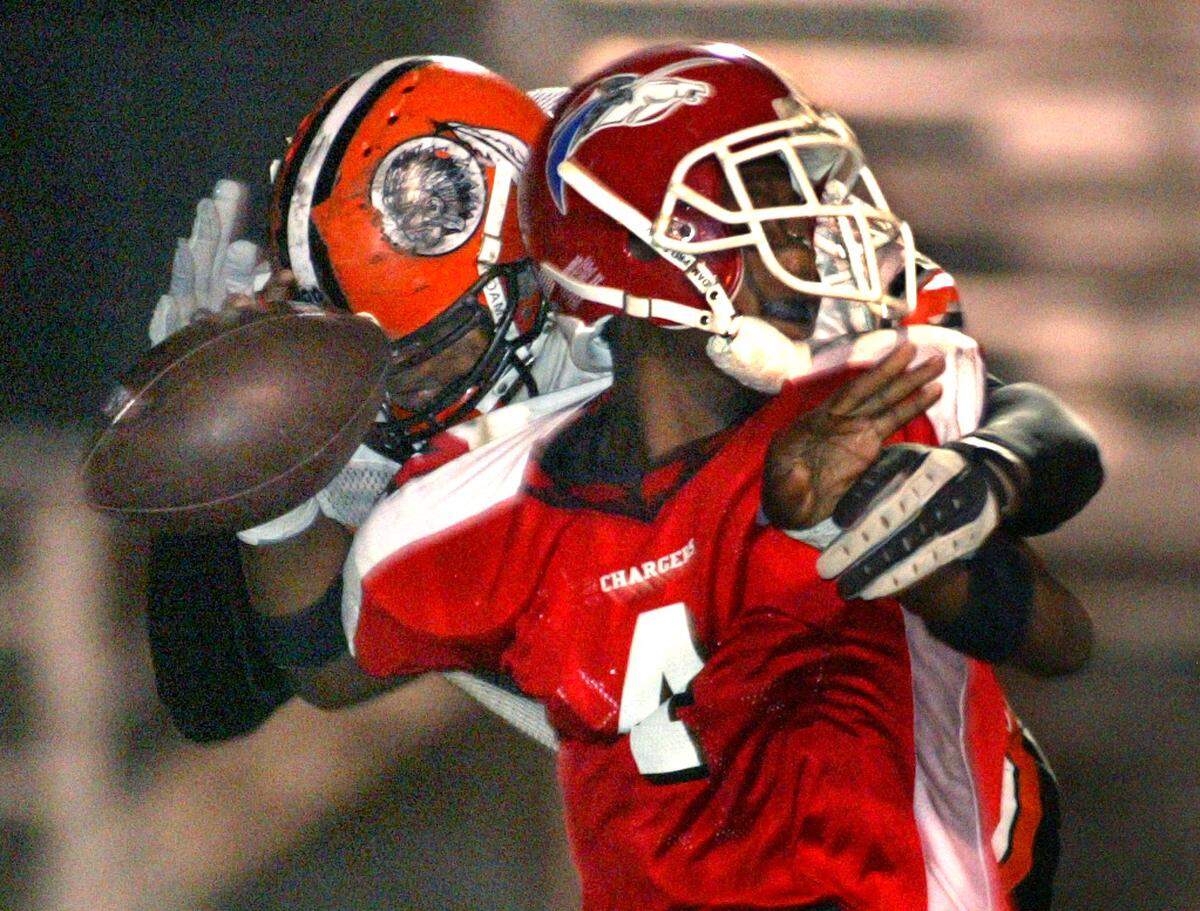 11/14/02--Al Diaz/Miami Herald Staff --Miami--At North Miami Stadium North Miami Beach vs Miami Carol City Senior on Thursday night. Carol City’s Maurice Charles sacks North Miami Beach quarterback E.J. Biggers who fumbles the ball. Charles recovers the fumble for a turnover in the second half.