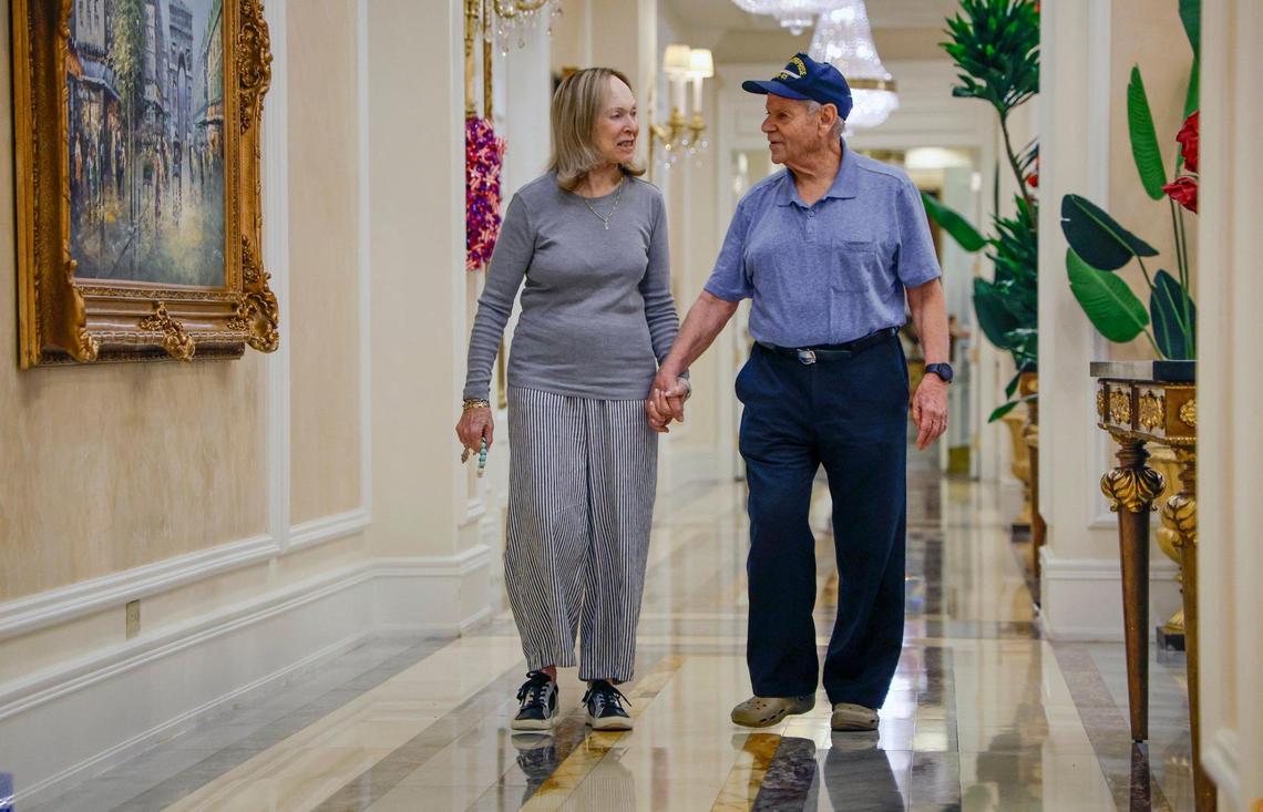 U.S. Navy veteran Dr. Jay Ellenby, who served on the USS Enterprise, walks with Teeny Turner inside The Palace in Coral Gables, Florida, on Thursday, Nov. 7, 2024.