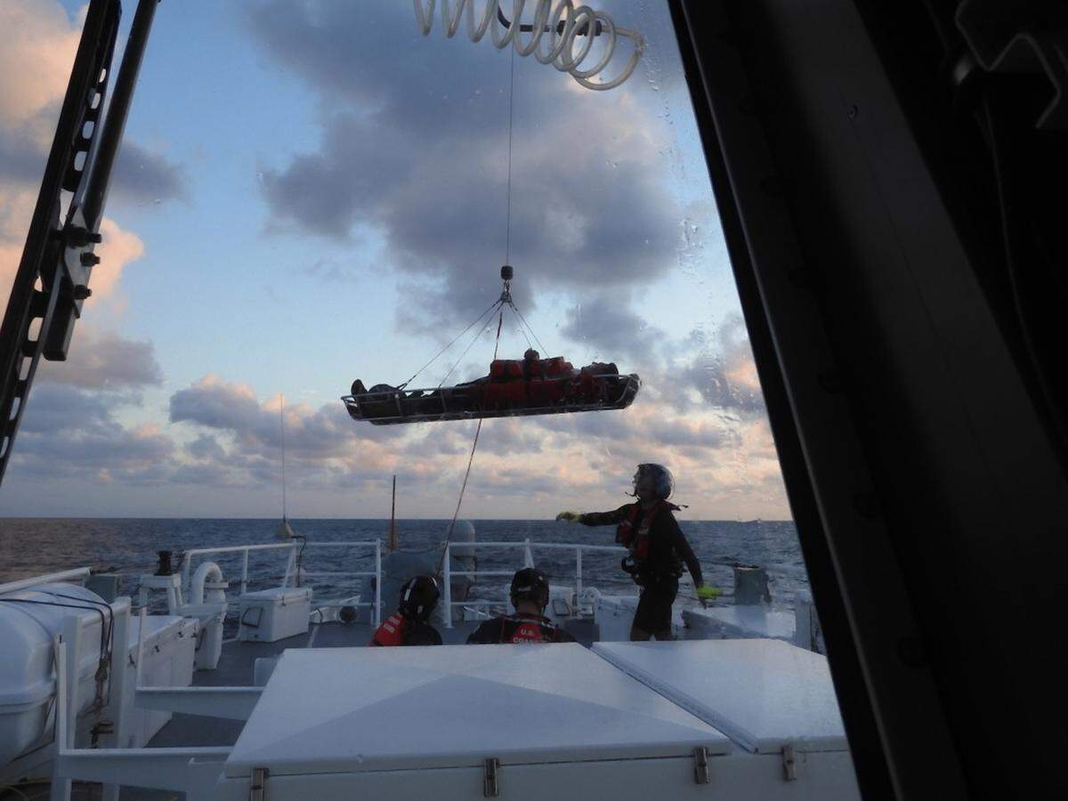 A Coast Guard Air Station Clearwater MH-60 Jayhawk helicopter crew hoists a patient after a boat collision, Oct. 15, 2019, 35 miles northwest of the Dry Tortugas.