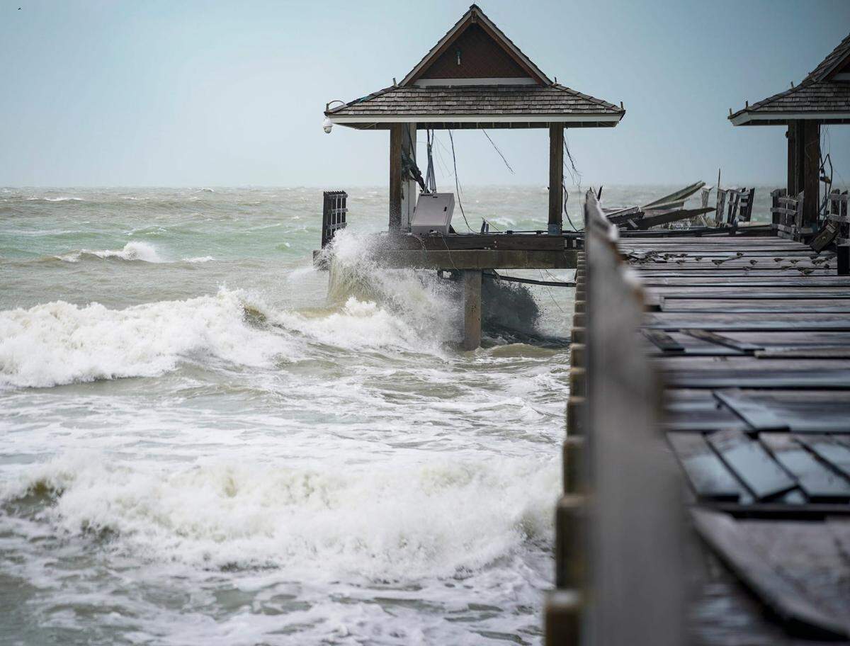 Waves crash at Naples Pier in Naples as Hurricane Helene passes off the coast on Thursday, Sept. 26, 2024.