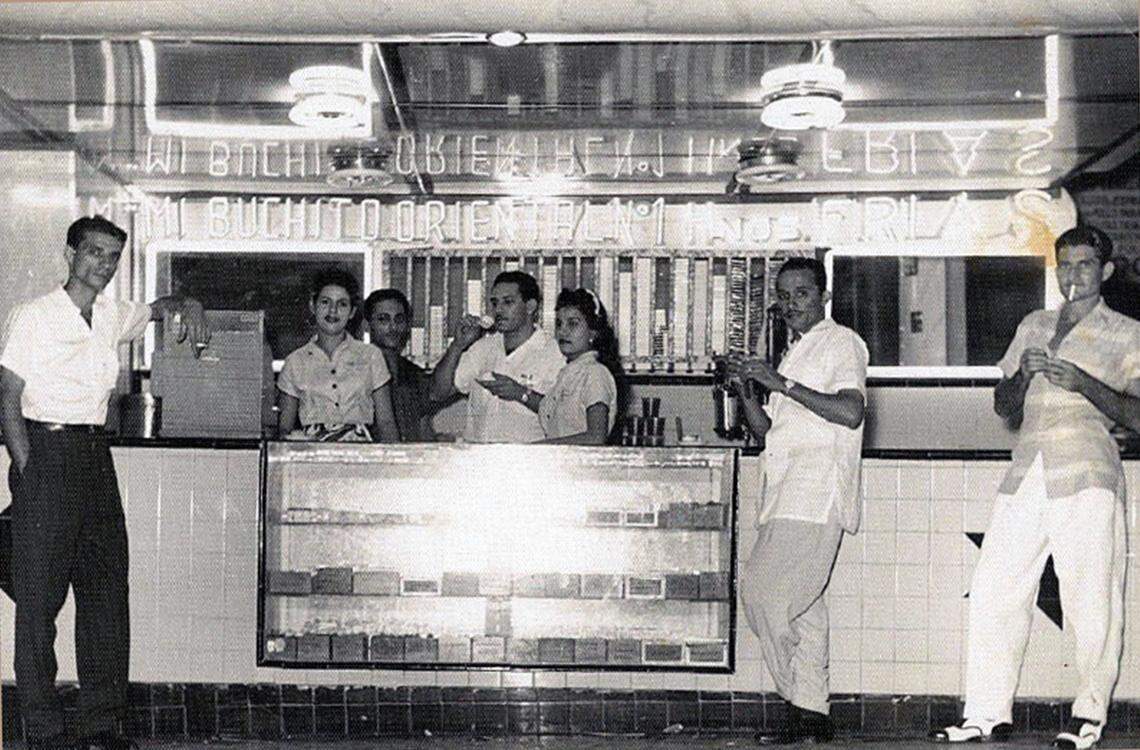 Coffee culture in Cuba was centered around outdoor carts and cafeterías, open-air counters where customers could pop by for cafecito at 3-5 cents a cup. The writer’s father, Fernando Frías, is pictured drinking a cup at his Mi Buchito Oriental cafetería in Marianao, Havana, circa 1957.