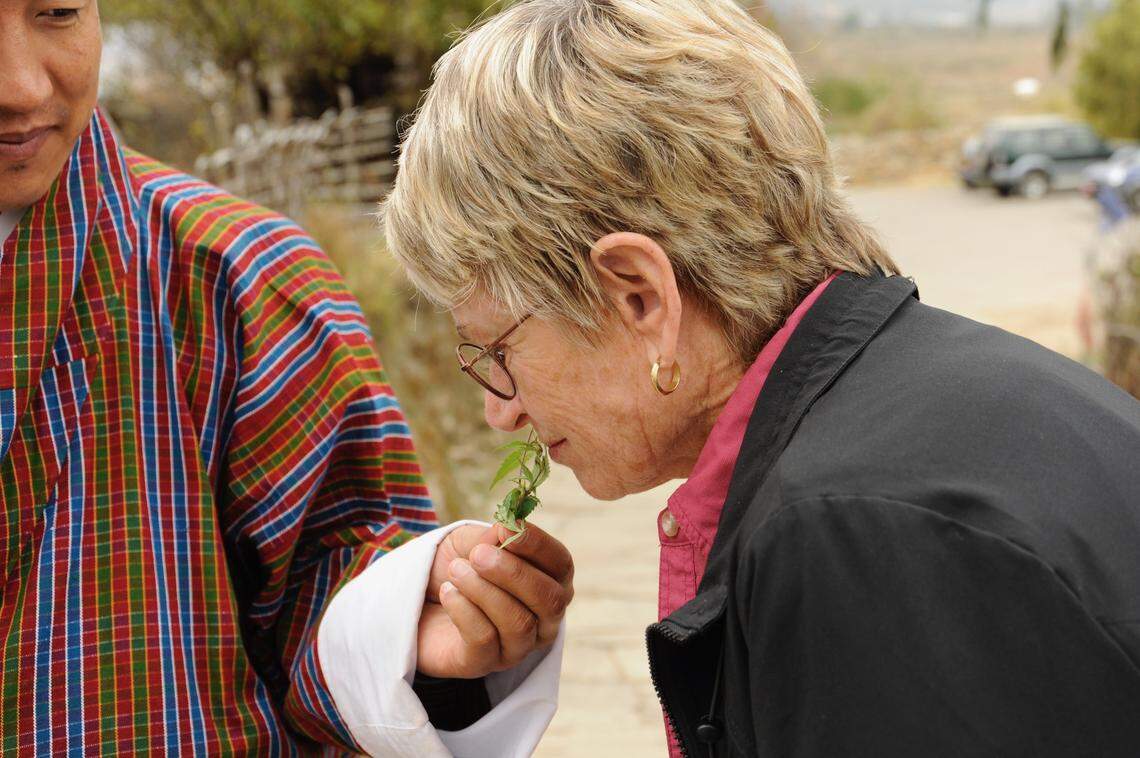 Georgia Tasker smelling an herb in Bhutan.