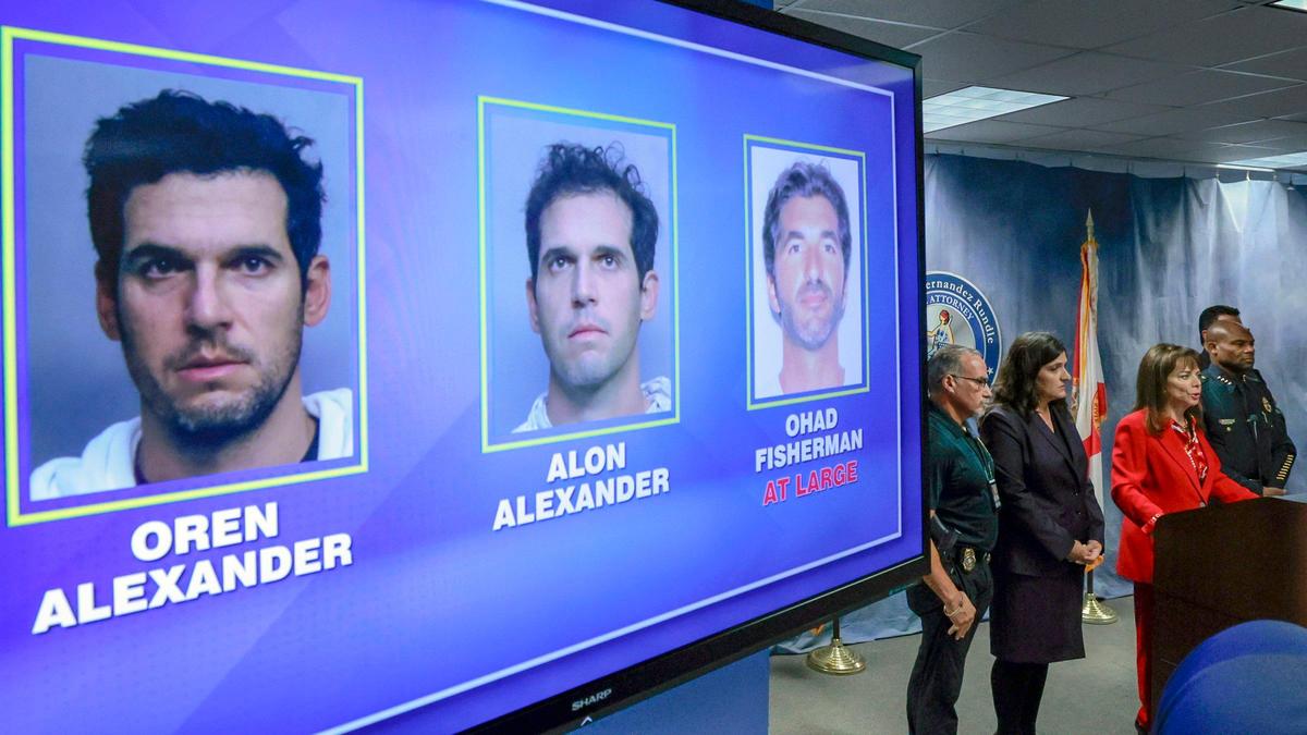 Photos of Oren and Alon Alexander, who were arrested Wednesday at their Miami Beach homes, are displayed during Miami-Dade State Attorney Katherine Fernandez Rundle’s press conference in Miami, Florida, on Wednesday, Dec. 11, 2024. Also displayed is a photo of Ohad Fisherman, a cousin of the Alexander brothers, who also is facing rape charges. He remained at large Wednesday.
