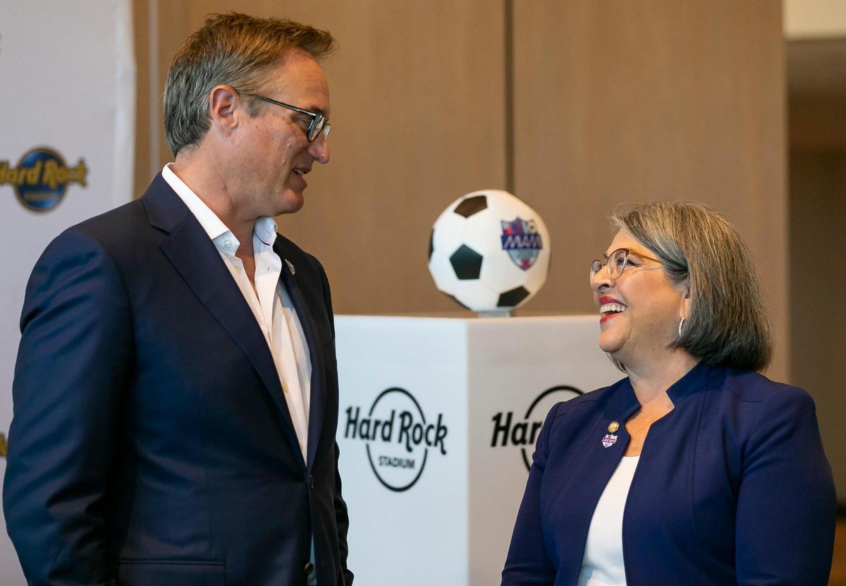 Tom Garfinkel, president and CEO of the Miami Dolphins and Hard Rock Stadium, and Miami-Dade County Mayor Daniella Levine Cava speak before the start of a press conference inside the Hard Rock Stadium on Friday, June 17, 2022, in Miami Gardens, Fla. The press conference was held a day after it was announced that Miami and the Hard Rock Stadium would host games during the 2026 FIFA World Cup.