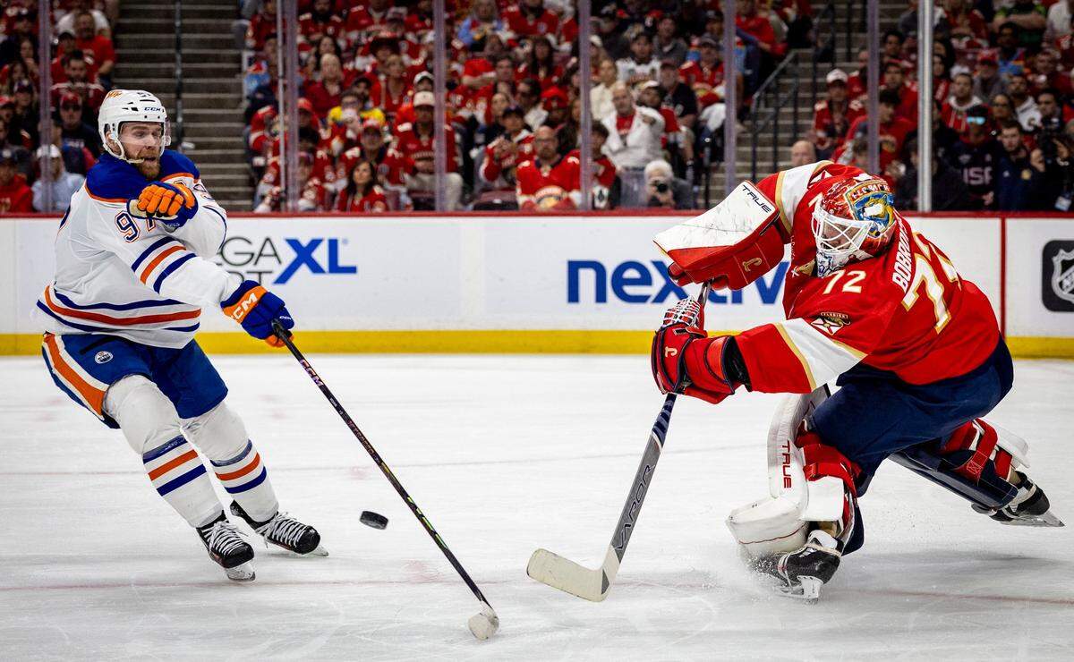 Florida Panthers goaltender Sergei Bobrovsky (72) clears the puck past Edmonton Oilers center Connor McDavid (97) during the second period of Game 6 in the NHL Stanley Cup Final series at Amerant Bank Arena on June 17, 2025, in Sunrise, Fla.