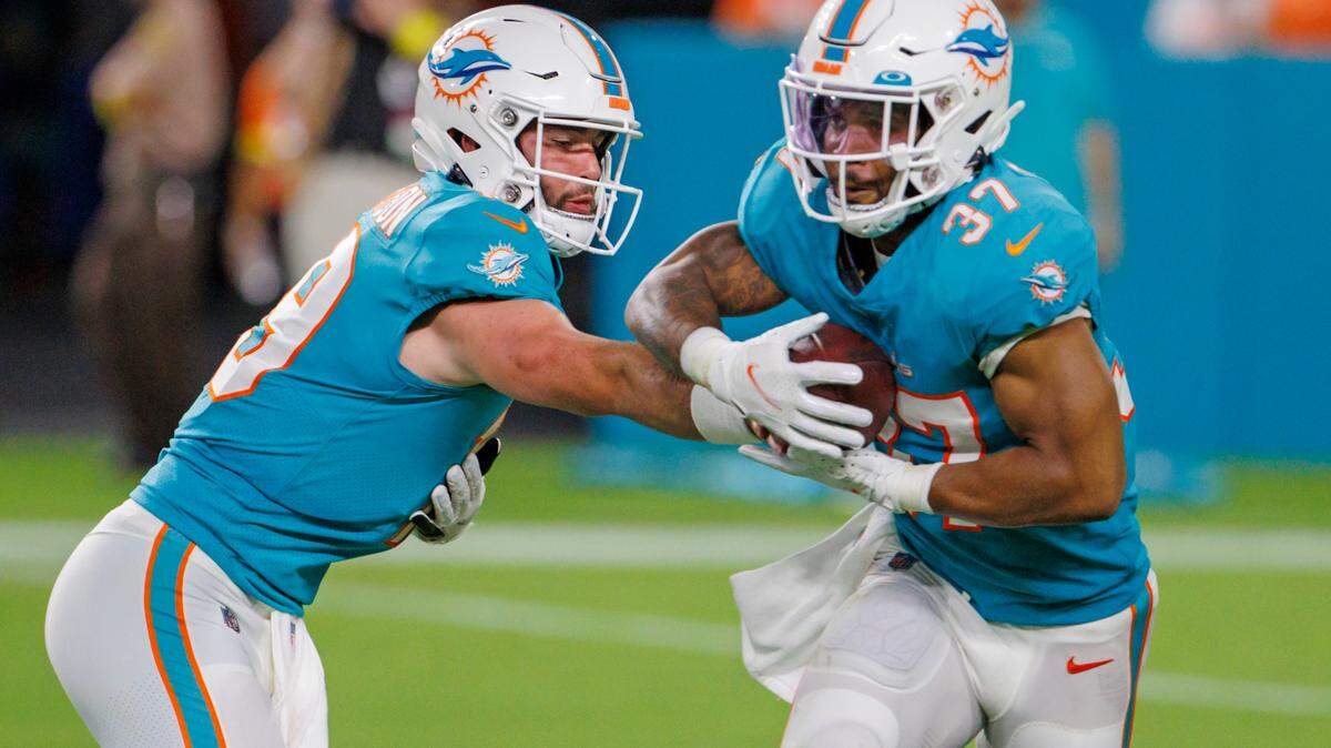Miami Dolphins quarterback Skylar Thompson (19) hand off to Dolphins running back Myles Gaskin (37) during third quarter of an NFL preseason football game against the Las Vegas Raiders at Hard Rock Stadium on Saturday, August 20, 2022 in Miami Gardens, Florida.