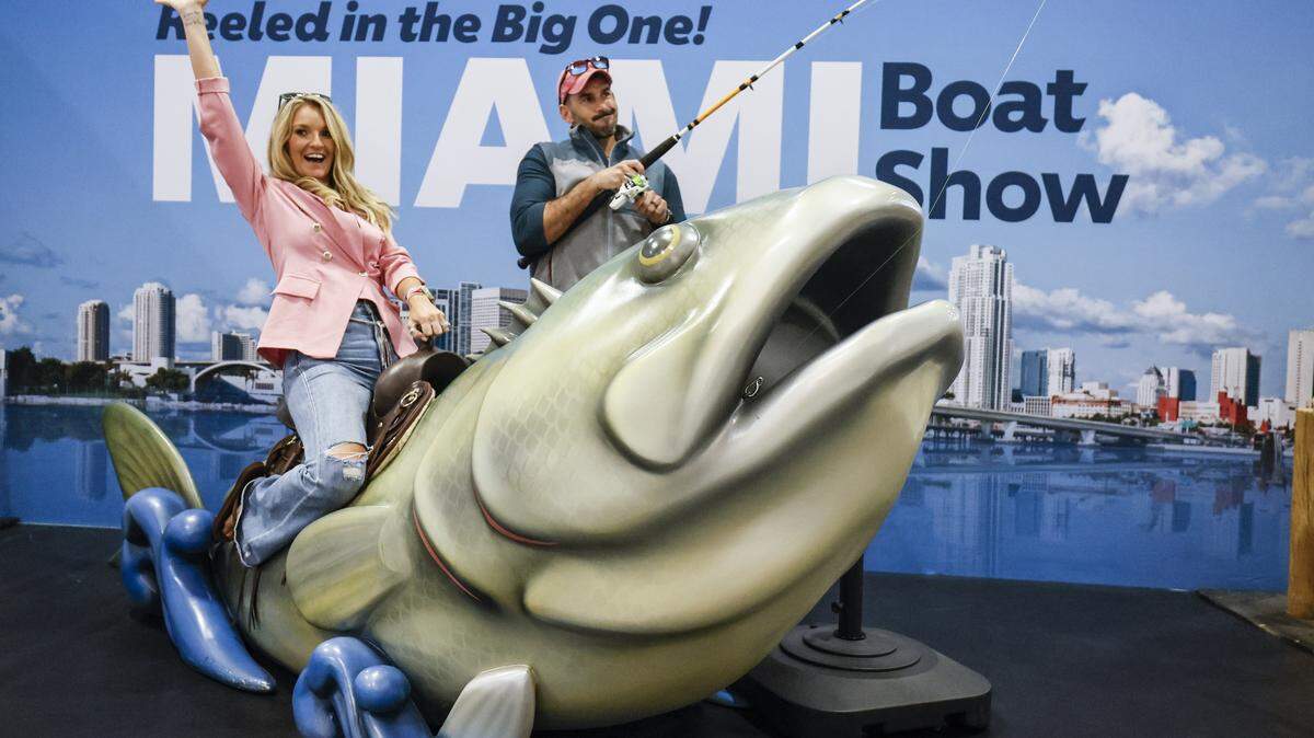 Kayla and Mark Hotze of Destin, Florida pose at a photo booth on display at the Miami Beach International Boat Show in the Miami Beach Convention Center on Miami Beach, FL, on Thursday, February 12, 2026