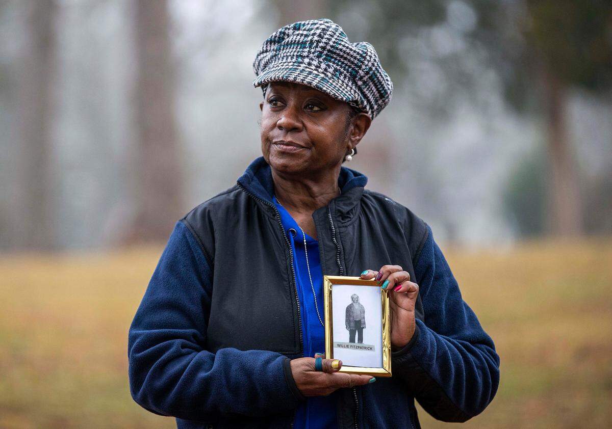 Peggy Fitzpatrick, 65, stands for a portrait holding an image of her great grandfather, Willie Fitzpatrick, at East Lake Park in Atlanta’s East Lake community, Thursday, Feb. 11, 2021. Willie was a victim of the Tuskegee Experiments, which was an unethical medical study that targeted Black men for more than 40 years. Despite this experiment being a part of Peggy’s family legacy, she is still seeking to participate in the COVID-19 vaccination. (Alyssa Pointer/Atlanta Journal-Constitution via AP)