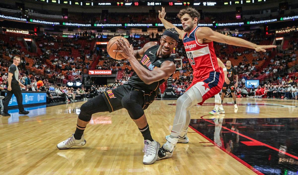 Heat forward Jimmy Butler battles Wizards guard Raul Neto in the second quarter of Miami’s win on Thursday at the FTX Arena. Butler finished with 24 points and five assists.