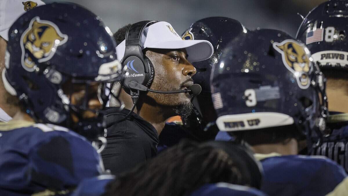 Florida International University Panthers head coach Willie Simmons huddles with players during a timeout on the field during the game against the Bethune Cookman Wildcats at FIU's Pitbull Stadium in Miami, Florida, on Friday, August 29, 2025.
