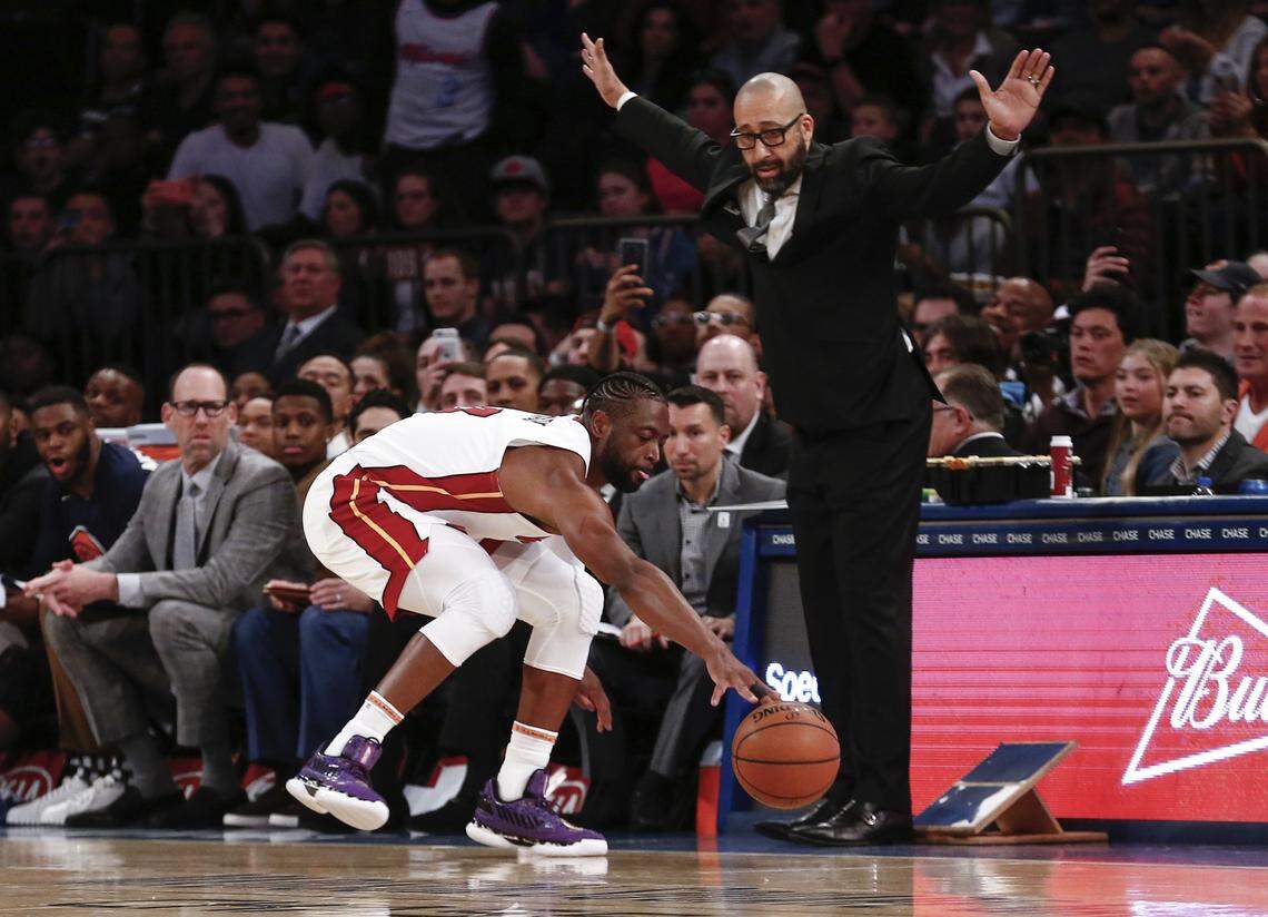 Miami Heat guard Dwyane Wade (3) dives for the ball while New York Knicks head coach David Fizdale reacts during the second half of an NBA basketball game on Saturday, March 30, 2019, in New York. The Heat won 100-92.