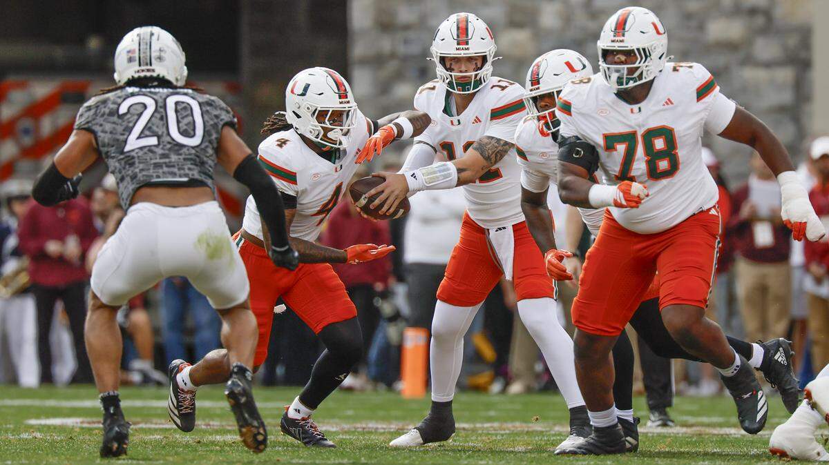 Miami Hurricanes running back Mark Fletcher Jr. (4) takes the handoff from quarterback Carson Beck (11) in the first half against the Virginia Tech Hokies at Lane Stadium in Blacksburg, Virginia, on Saturday, November 22, 2025.