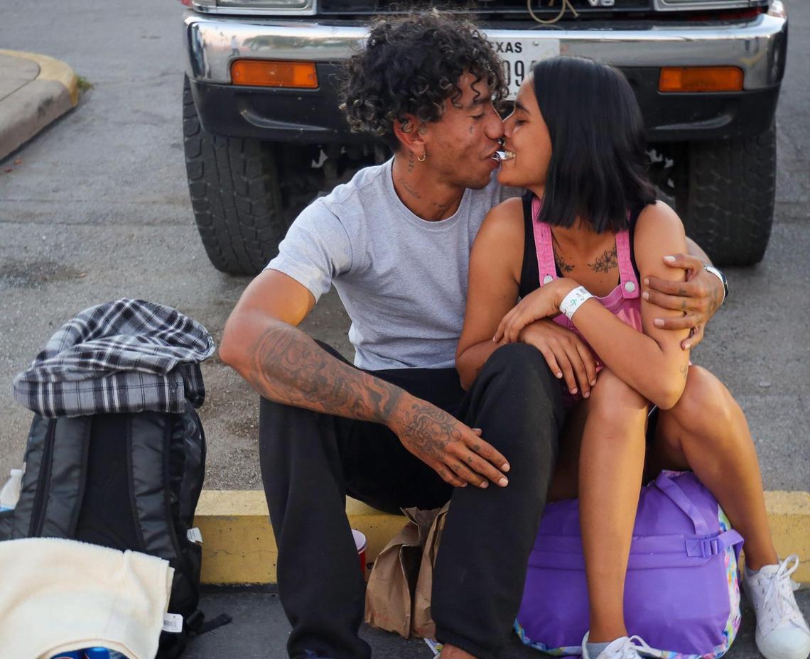 Juli Soto, 23, kisses her husband outside the San Antonio migrant shelter as the young Venezuelan couple waits for a bus to the airport to catch a flight to Miami, where they hoped to build a new life.