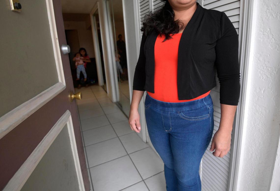 Maria, an undocumented migrant who was separated from her daughter at the southern border in 2018, stands at the entrance to her family’s apartment, Sunday, Aug. 30, 2020, in Orlando.