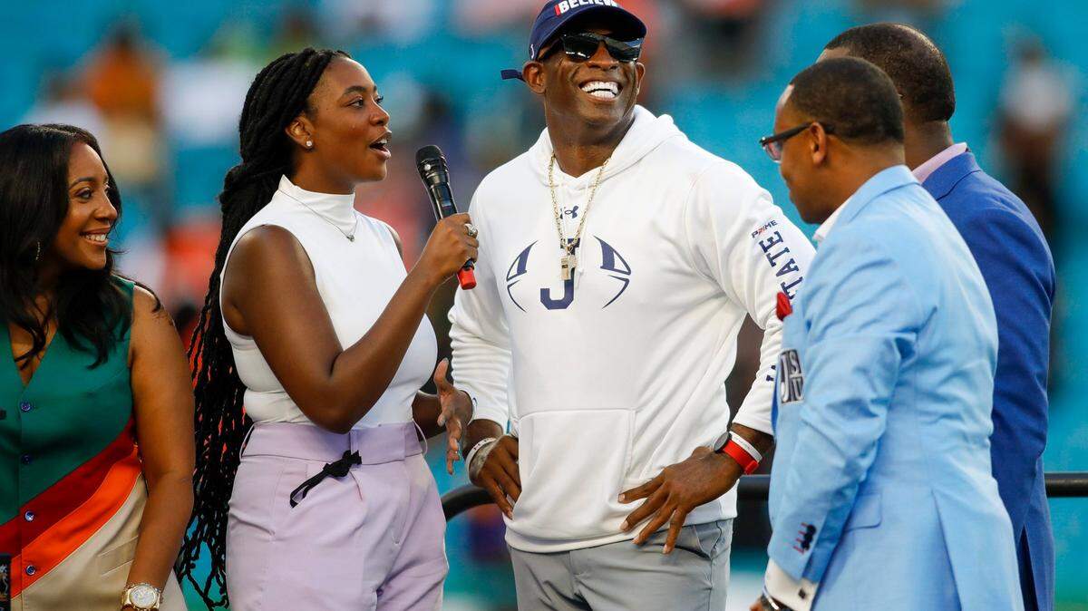 Jackson State Tigers head coach Deion Sanders, center, smiles while being interviewed after winning the Orange Blossom Classic against the Florida A&M Rattlers at Hard Rock Stadium in Miami Gardens, Florida, Sunday, September 4, 2022.