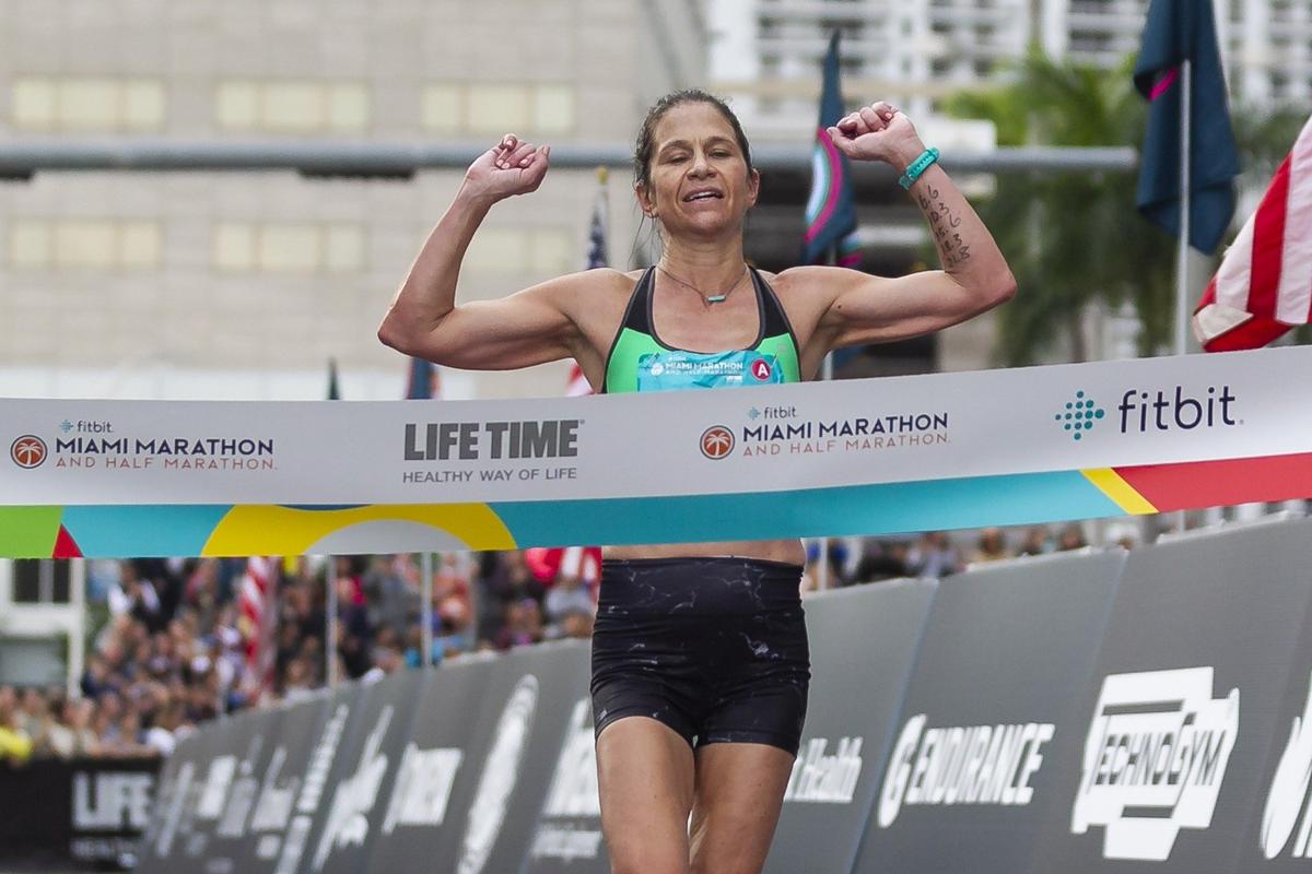 Kate Landau, 42, of Tacoma, Washington, reaches the finish line of the Miami Marathon on Sunday, Jan. 27, 2019. Landau placed first in the women’s category with a final time of 2:37:45.