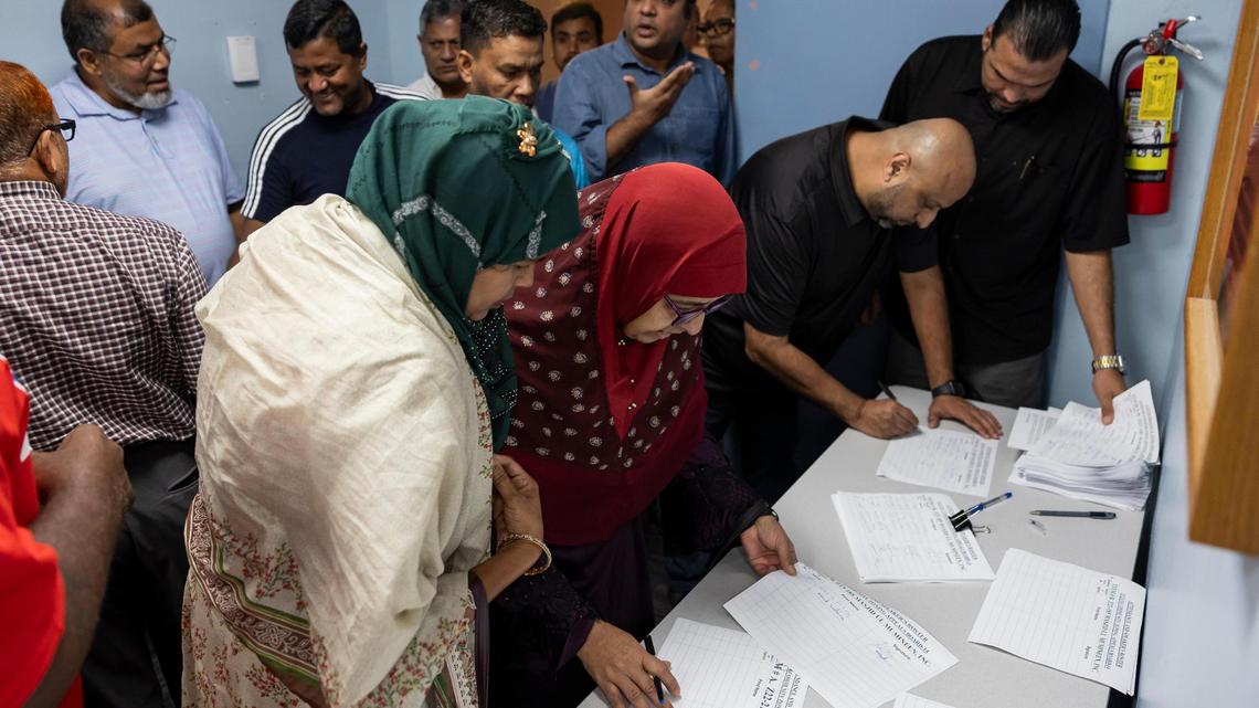 People sign in to for zoning meeting on a proposed cemetery for Muslims at the South Dade Regional Library in early November. This week, a board rejected the request.