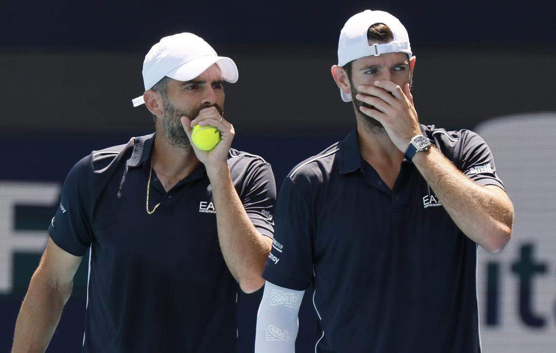 Italy's Simone Bolelli and Andrea Vavassori cover their mouths as the talk to each other during doubles match against Harri Heliovarra of Finland and Henry Patten of Great Britain in the stadium during the Miami Open in Miami Gardens, Florida, on Saturday, March 28, 2026.