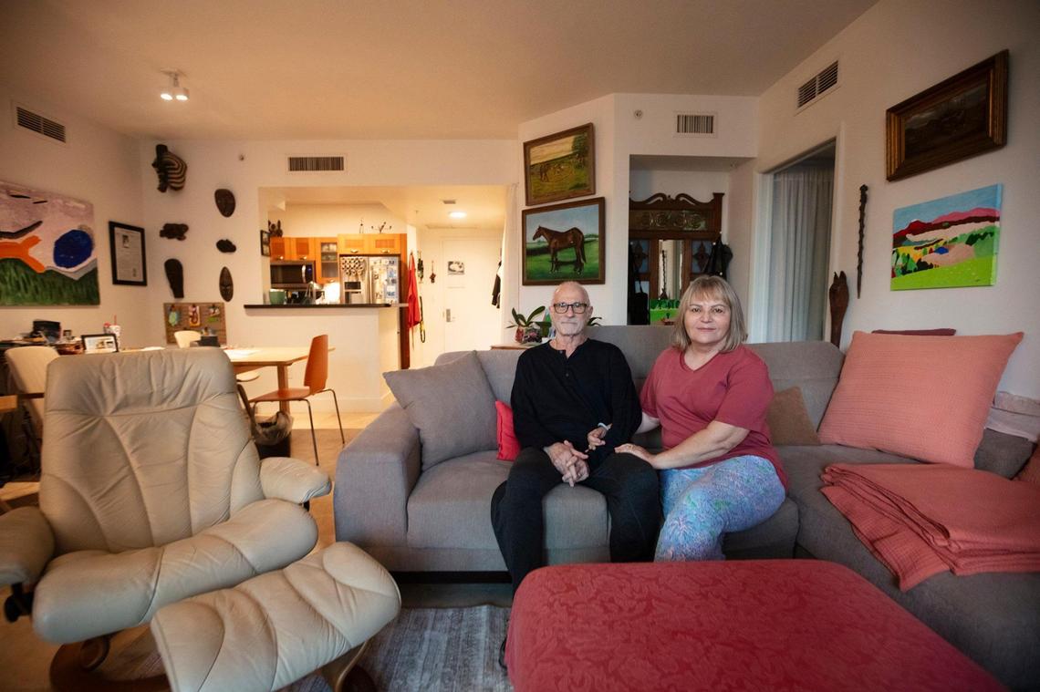 Gil Hall and Elizabeth Czerny sit in their home at the Solaris at Brickell Bay condo building in Miami on Tuesday, Jan. 21, 2025. The couple is part of a group that has rejected offers to buy their units.
