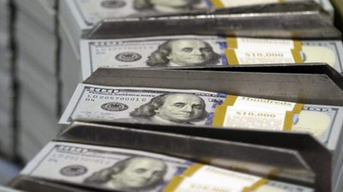 Just-cut stacks of $100 bills move down the line at the Bureau of Engraving and Printing Western Currency Facility in Fort Worth, Texas.