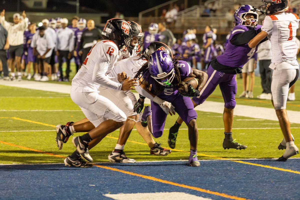 True North running back Cecil Smith powers into the end zone during the Titans’ 62-28 win over Boca Raton St. Andrews in a Region 4-1A semifinal on Thursday night at Tropical Park.