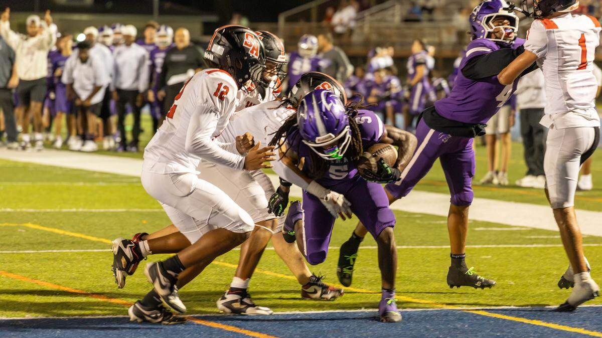 True North running back Cecil Smith powers into the end zone during the Titans’ 62-28 win over Boca Raton St. Andrews in a Region 4-1A semifinal on Thursday night at Tropical Park.