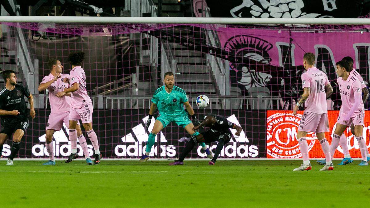 Inter Miami goalkeeper Nick Marsman (21) looks to block a header from Houston Dynamo midfielder Fafà Picault (10) during the first half of their MLS soccer match at DRV PNK Stadium on Saturday, April 2, 2022, in Fort Lauderdale, Florida.
