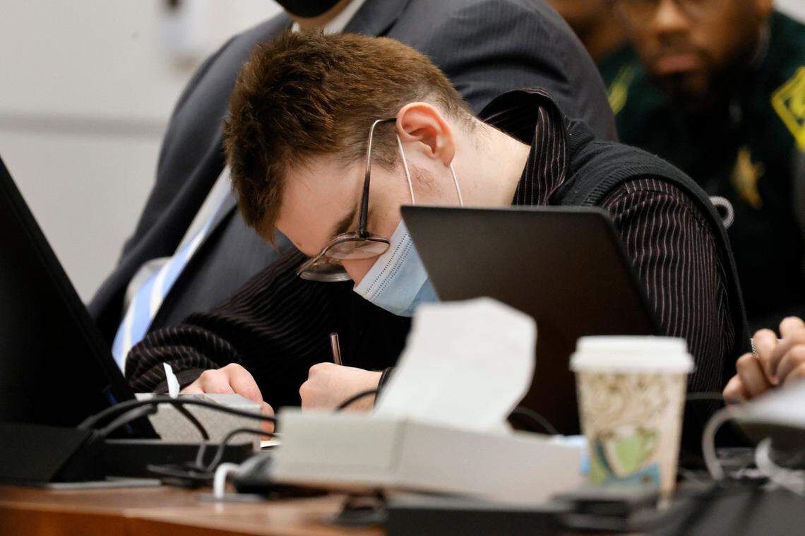 Marjory Stoneman Douglas High School shooter Nikolas Cruz writes while seated at the defense table for the penalty phase of his trial at the Broward County Courthouse in Fort Lauderdale on Friday.