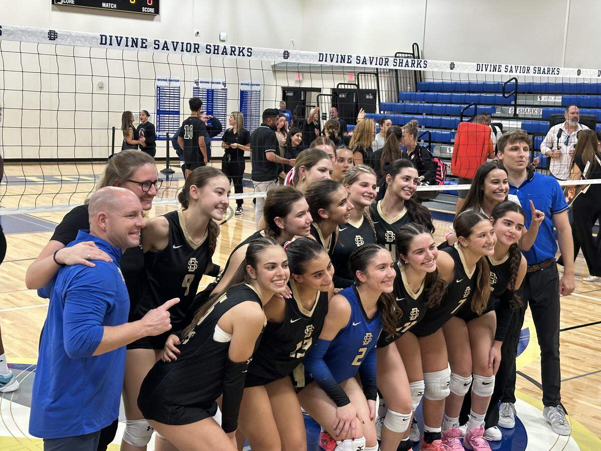 The Divine Savior girls’ volleyball team celebrates after beating Westminster Christian in the Region 4-2A final on Tuesday at Divine Savior Academy in Doral, Fla.