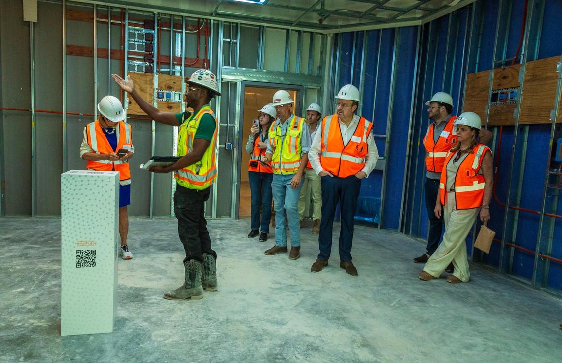 Field Superintendent Edward Jackson (center) leads a tour with guests attending the topping off ceremony at the construction site where the new UHealth at SoLé Mia medical facility, is being built in North Miami on Friday April 05, 2024.