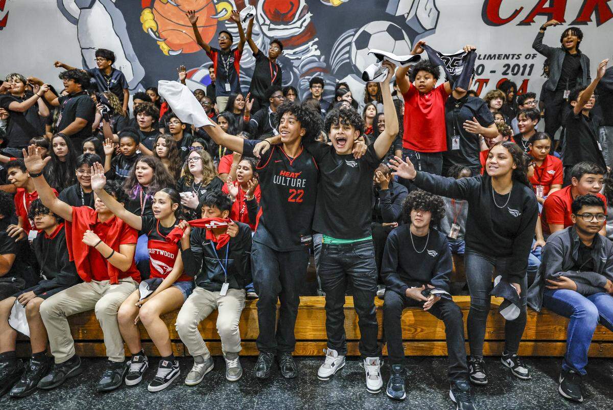 Students, David Trinidad, Sebastian Recendiz, and Sarah Alonso, jump up in celebration of Earth Day as the Miami Heat began the day's events with a pep rally at Driftwood Middle School in Hollywood, Florida, on Thursday, April 9, 2026. Miami Heat's efforts aim to bolster Driftwood's environmental programs and curriculum, which have already earned the school national and state recognition.