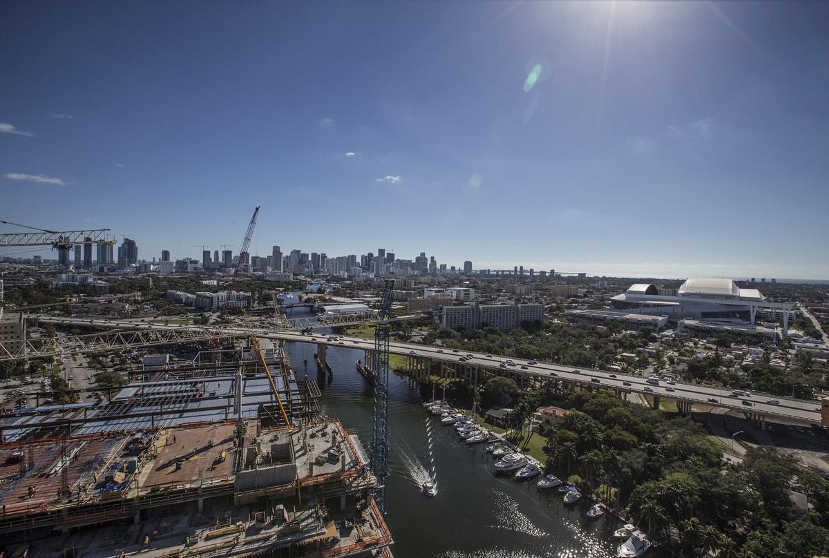 A boat heads west on the Miami River past the River Landing construction site on Monday January 7, 2019.
