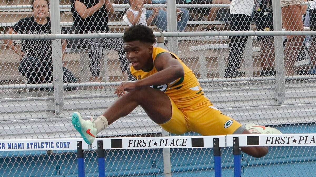 Miami Jackson’s Byron Holt wins boys’ 110 meter hurdles during the GMAC Track and Field Championship on Thursday, April 7, 2022 at Traz Powell Stadium in Miami. Andrew Uloza / for THE MIAMI HERALD
