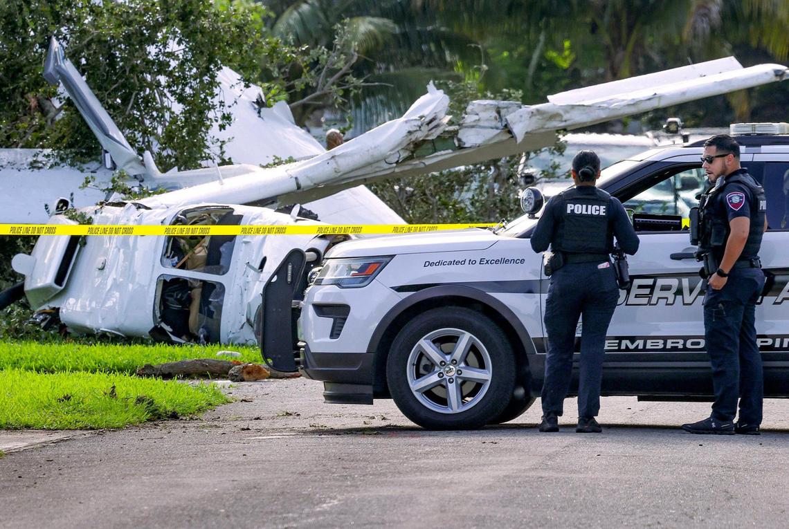 A small plane rests in a front lawn after it crashed in a residential neighborhood near North Perry Airport in Pembroke Pines on Sunday night, July 13, 2025, injuring four people. The aircraft was coming from the Turks and Caicos in the Caribbean and was about to land, records show.