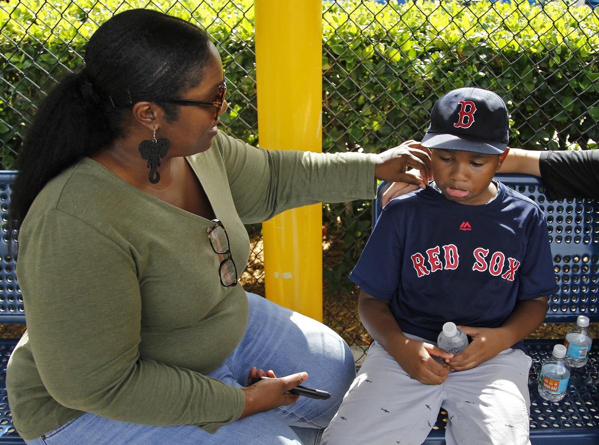 After he was hit with a ball inside the batting cage, Garth Fowler, 9, gets encouragement from his mom, Carla Cody, to get back to participating in North Miami Beach Little League’s Baseball Buddies program on Sunday, Nov. 4, 2018.