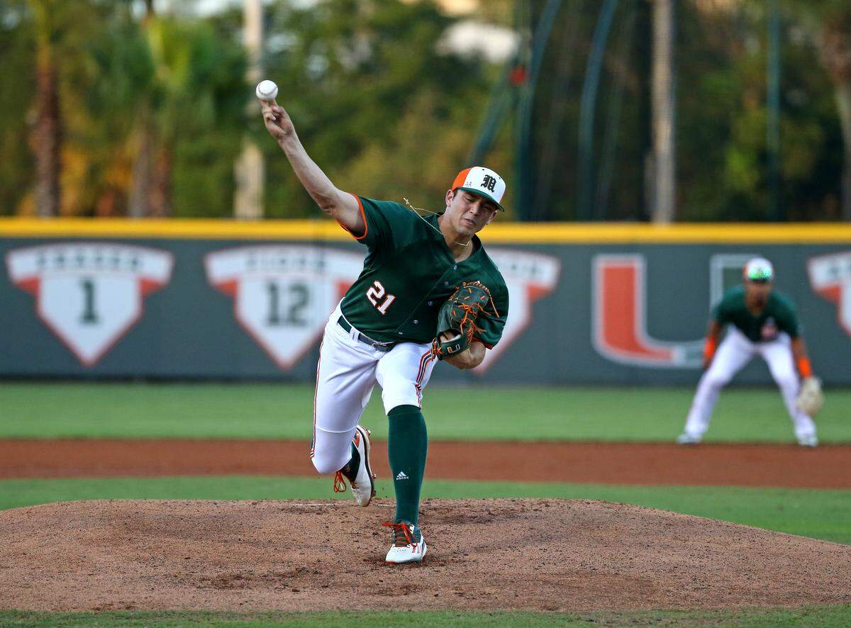 Miami Hurricanes pitcher Slade Cecconi (21) pitches during the first inning of a NCAA baseball game against the Florida Atlantic University Owls at Alex Rodriguez Park at Mark Light Field on Wednesday, February 20, 2019 in Coral Gables.