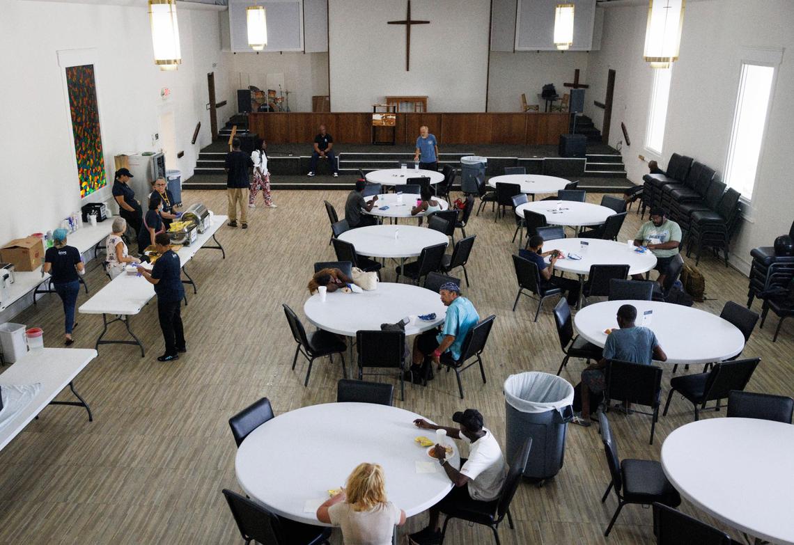 Volunteers serve lunch to people in the community on Thursday, Sept. 5, 2024, at HOPE South Florida in Fort Lauderdale. “It converts to a feeding place during the week, but on Sundays, it’s a chapel,” said volunteer Verel Johnson.