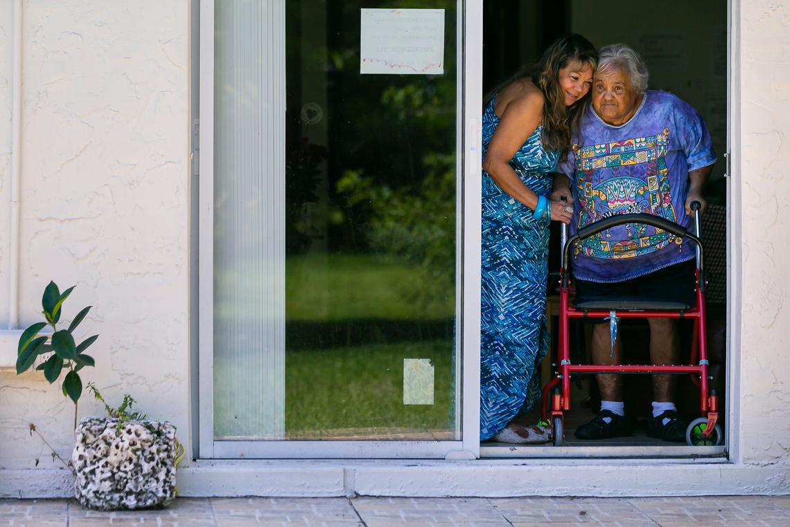 Mily Lopez, 57, left, gives her mother, Milagro Morales, a hug at their home in Miami’s Fontainebleau neighborhood on Saturday, May 9, 2020. Lopez is taking care of her 81-year-old mother, who has dementia, and her 95-year-old father-in-law.