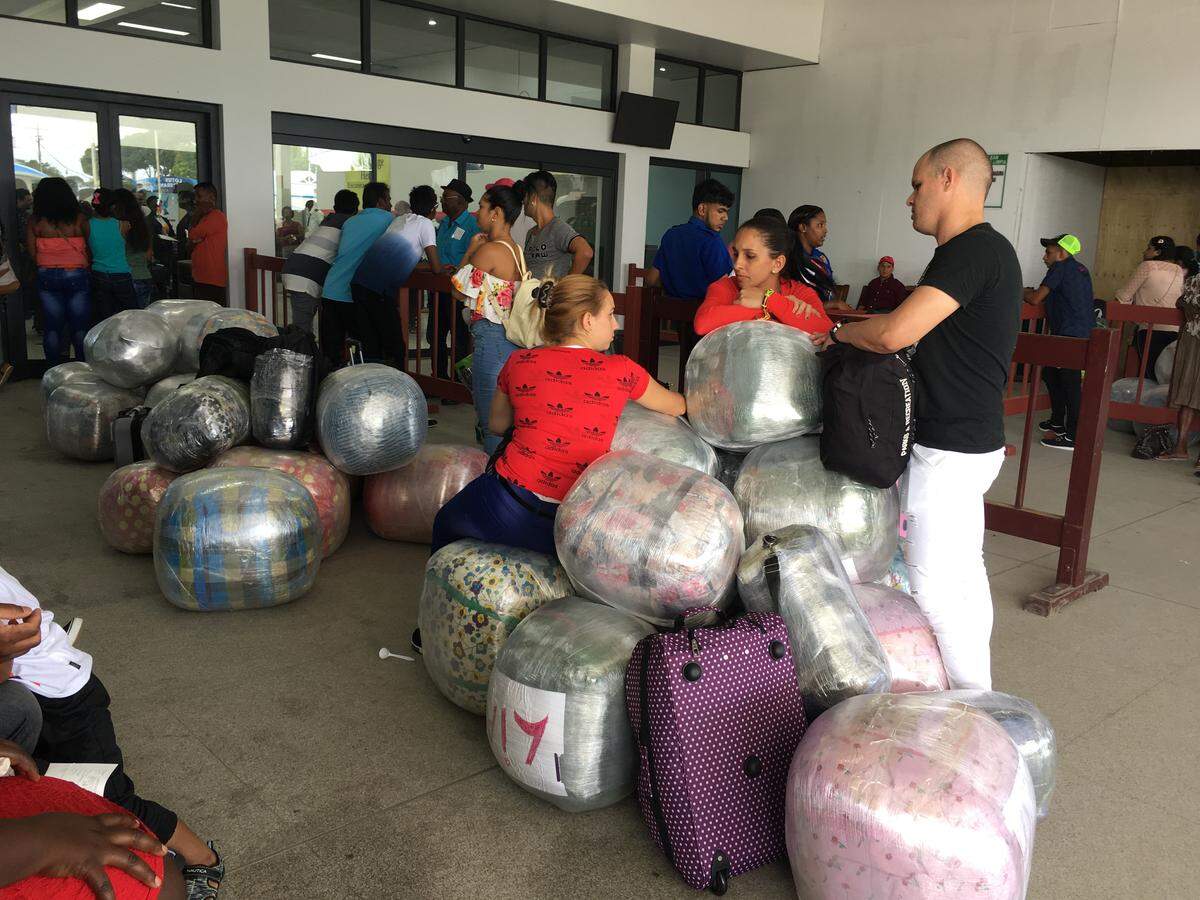 Cubans head home from the Georgetown airport loaded down with purchases made in Guyana.