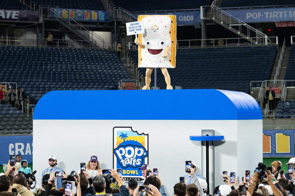 Dec 28, 2023; Orlando, FL, USA; Pop Tart mascot signals the end of the celebration after the game at Camping World Stadium. Mandatory Credit: Jeremy Reper-USA TODAY Sports