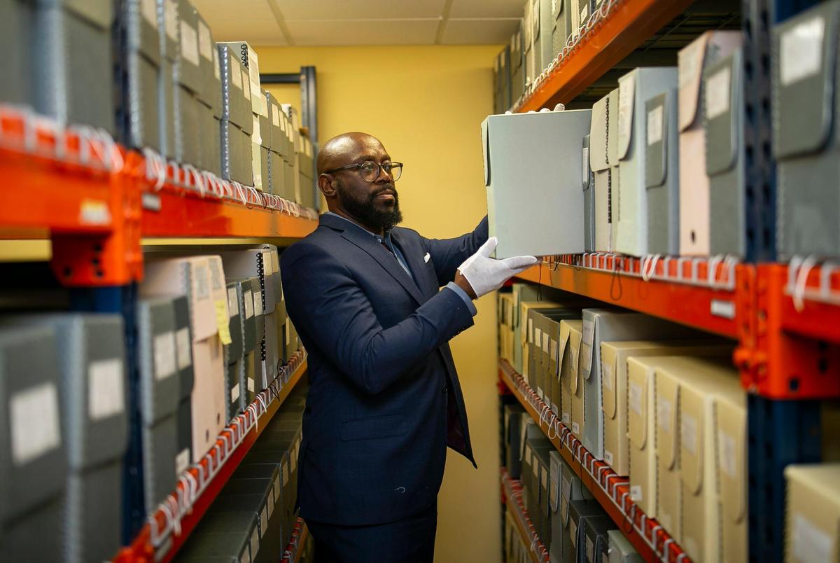Timothy Barber, executive director of the Black Archives History and Research Foundation of South Florida, looks through the Archives’ vault on Wednesday. Barber, who has led the Archives since 2009, is stepping down to become director of Florida Agricultural and Mechanical University’s Meek-Eaton Black Archives Research Center and Museum.