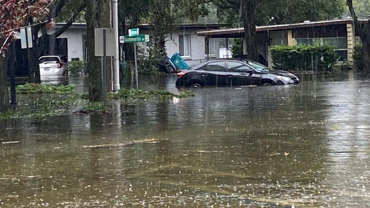 Ian left this car — and many others in the Orlando area — nearly door handle deep in rainwater.