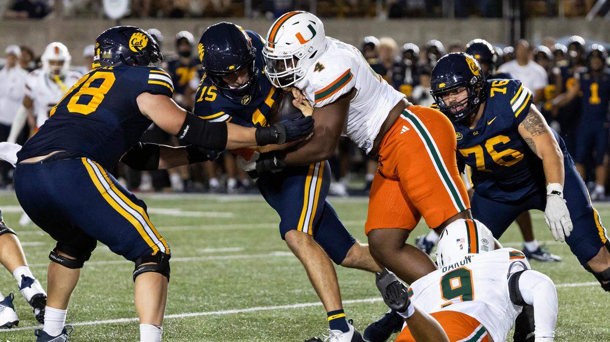 California Golden Bears quarterback Fernando Mendoza (15) is sacked by Miami Hurricanes defensive lineman Rueben Bain Jr. (4) in the second half of their NCAA college football game at the California Memorial Stadium on Saturday, Oct. 5, 2024, in Berkeley, Calif.