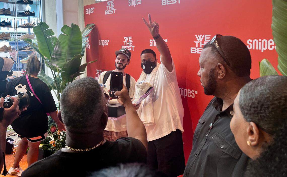 DJ Khaled poses with a fan at the grand opening of the We The Best SNIPES store on Thursday, August 3, 2023 in Miami Beach, Florida. Complete with a recording studio, homages to Art Deco and even an Aston Martin-inspired watersports vehicle, the store aims to provide an “unique shopping experience like no other,” DJ Khaled said in a statement.
