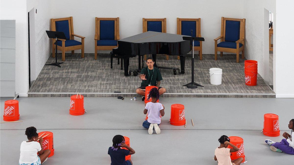 Juan Posso of the Donna E. Shalala MusicReach Program, teaches rhythm patterns to a group young girls at the historic St. Mary First Missionary Baptist Church. It’s one of the church properties that nonprofit, Sanctuary of the Arts, bought and repurposed into a performing arts theater and dance studio.