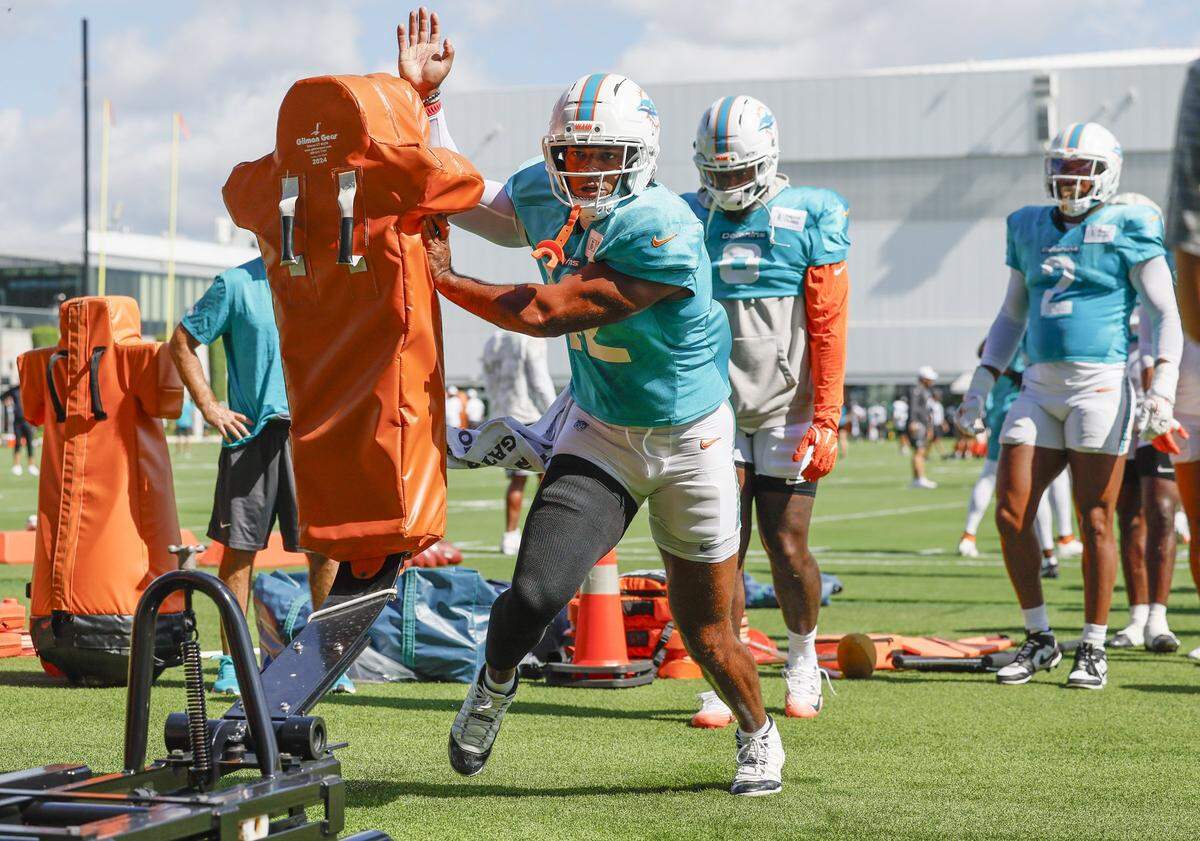 Miami Dolphins linebacker Grayson Murphy (42) hits a blocking dummy during an NFL football joint practice with the Jacksonville Jaguars.