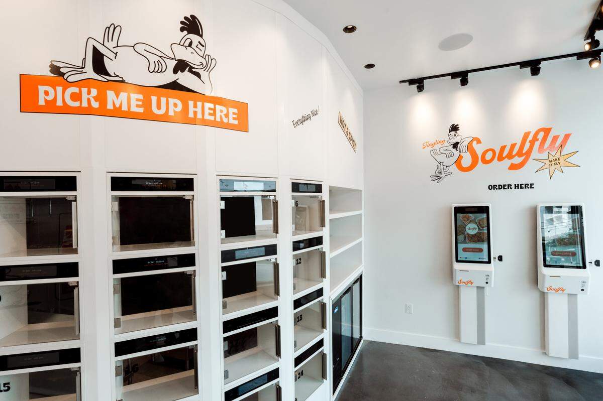 At the new Soulfly Chicken in Wynwood, customers order at the kiosks on the right, then pick up orders on the left.